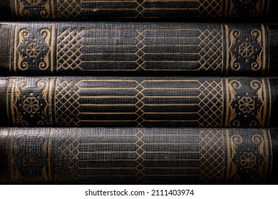 A stack of old books in hard leather binding