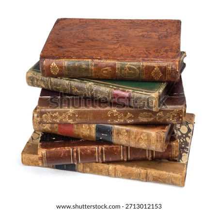 Stack of old books with leather covers placed on a white background. A stack of antique old books
