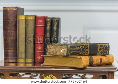 A stack of old books on the coffee table.