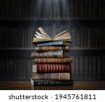 A stack of old books on table against background of bookshelf in library. Ancient books as a symbol of knowledge, history, memory and information. Conceptual background on education, literature topics