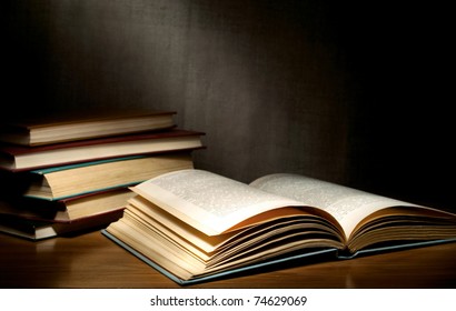 A Stack Of Old Books On The Table