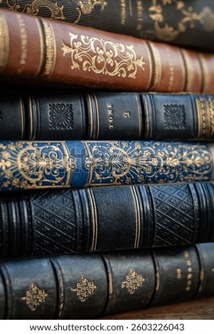 A stack of old books on table in library. Ancient books as a symbol of knowledge, history, memory and information. Conceptual background on education, literature topics.