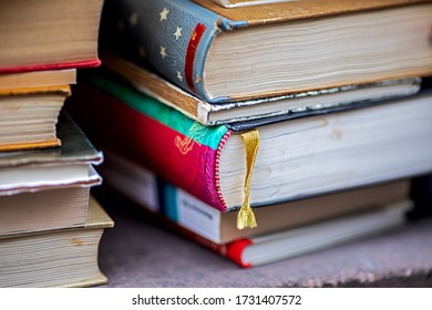 A Stack Of Old Books For Sale, A Book With Yellow Fabric Bookmark