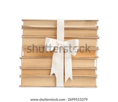 Stack of old books tied with white ribbon education and knowledge gift reading and learning concept isolated on white background