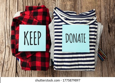 Stack of old clothes to discard (declutter) or keep. Recycle clothes, eco cotton.
