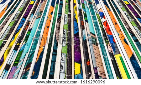 Stack of old comic books creates colorful paper background texture