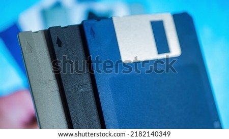 Stack of old diskettes in men hand