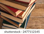 Stack of old hardcover books on wooden background, closeup