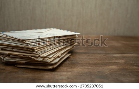 A stack of old letters on the table.Write letters.Send a mail envelope.
