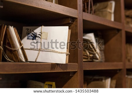 Stack of old letters on a wooden bookcase. Old mail of the post office