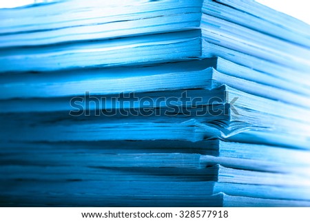 Stack of old magazines as background in toning