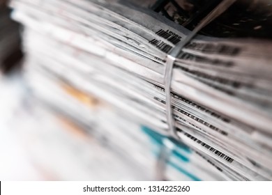 Stack Of Old Newspaper Tied Together Using Rope Stored On Wooden Shelf In The Archive Zone Of A Library