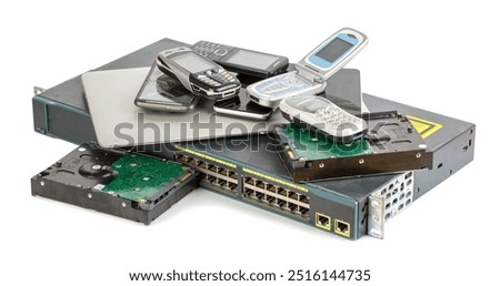 Stack of old and obsolete technic. Laptop, Hard disk drives, old vintage mobile phones isolated on white background.