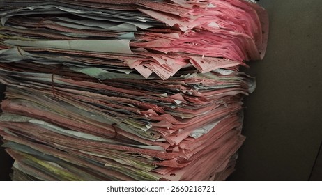 Stack of old paper documents in messy archive. Office filing background