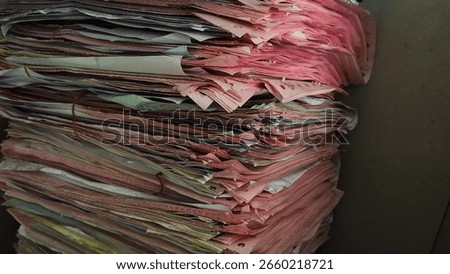 Stack of old paper documents in messy archive. Office filing background