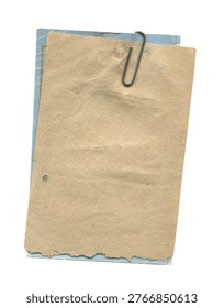 Stack of old paper tags clipped together with a metal paper clip showing worn edges and aged texture isolated on a white background
