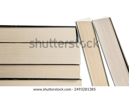 Stack of old paperback books on white background. These books are made of recycled paper
