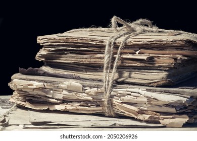 Stack of old papers and books tied with rope