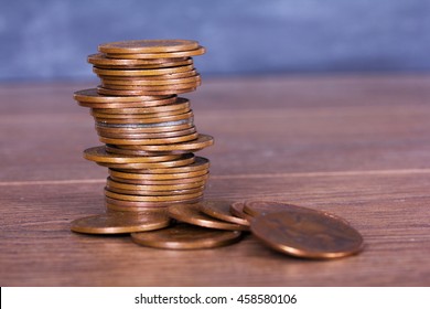 Stack of old penny coins on a wooden surface - Shutterstock ID 458580106
