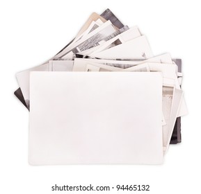 Stack of old photos with empty frame for photo isolated on white