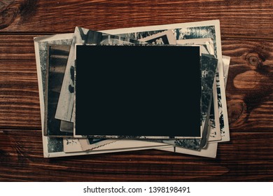 Stack old photos on table. Mock-up blank paper. Postcard rumpled and dirty vintage. Retro card