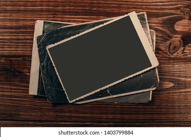 Stack old photos on table. Mock-up blank paper. Postcard rumpled and dirty vintage. Retro card