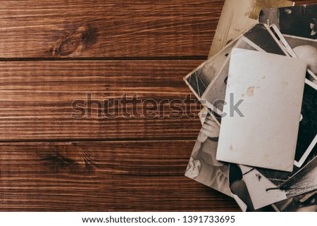 Stack old photos on table. Mock-up blank paper. Postcard rumpled and dirty vintage. Retro card