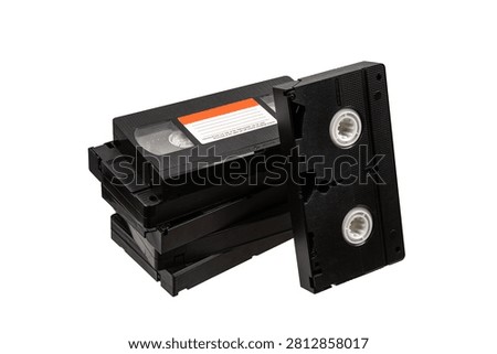 Stack of old retro VHS videotapes isolated on a clean white background.