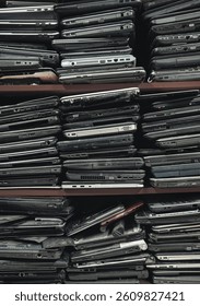 Stack of an old, used and damaged laptops background with copy space
