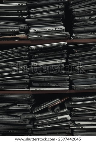 Stack of an old, used and damaged laptops background with copy space