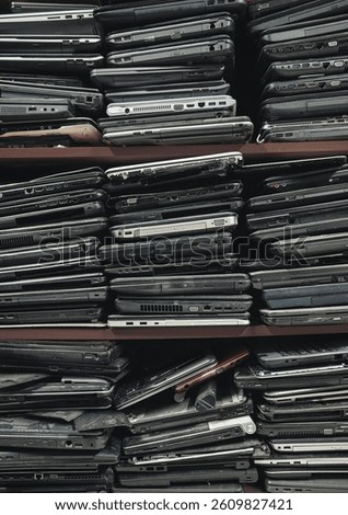Stack of an old, used and damaged laptops background with copy space