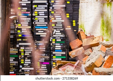 Stack Of Old VHS Video Cassettes In Ruined Video Store