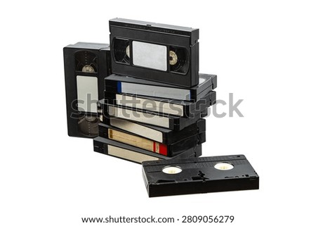 A stack of old VHS videotapes with blank labels isolated on a white background.