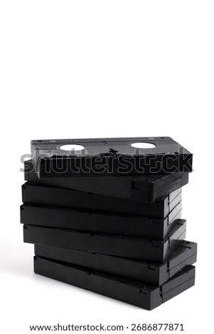 Stack of old VHS videotapes, on white background