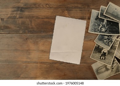 stack of old vintage monochrome photographs 1950 on photographic paper on natural wood background, concept of genealogy, memory of ancestors, family tree, nostalgia, childhood, remembering - Shutterstock ID 1976005148
