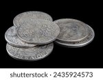 Stack of old vintage silver medieval taller coins on black background