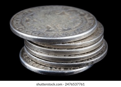 Stack of old vintage silver medieval taller coins on black background