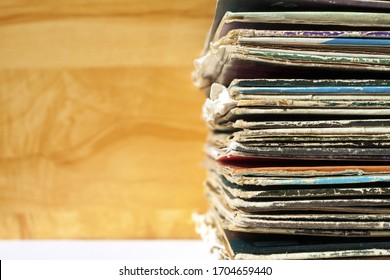 Stack of old vinyl records, close-up. Vinyl albums and records in a music store, vintage process. Retro styled image of boxes with vinyl record players.