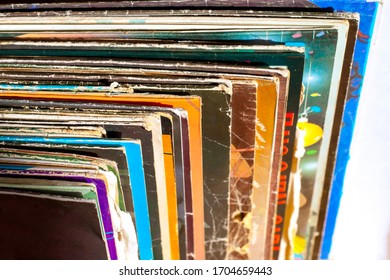 Stack of old vinyl records, close-up. Vinyl albums and records in a music store, vintage process. Retro styled image of boxes with vinyl record players.