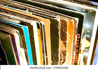 Stack of old vinyl records, close-up. Vinyl albums and records in a music store, vintage process. Retro styled image of boxes with vinyl record players.