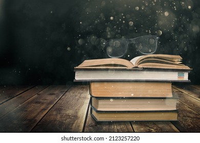 Stack Of Old Worn Shabby Books In Leather Binding In The Dark.