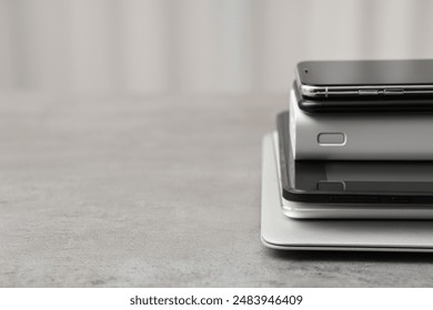 Stack on modern gadgets on grunge table indoors
