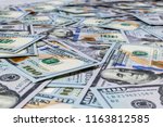 Stack of one hundred dollar bills. Stack of cash money in hundred dollar banknotes. Heap of hundred dollar bills background. Concept of financial success.