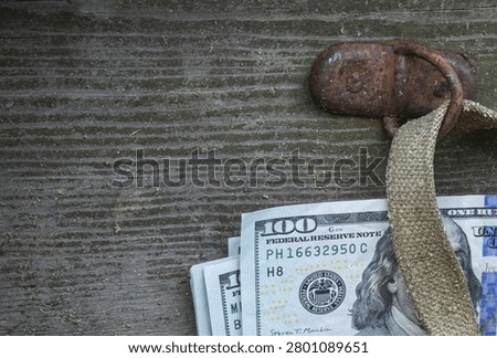 Stack of One Hundred Dollar Bills Hidden Under Old Vintage Wooden Chest