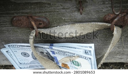 Stack of One Hundred Dollar Bills Hidden Under Old Vintage Wooden Chest