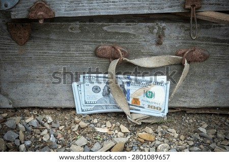 Stack of One Hundred Dollar Bills Hidden Under Old Vintage Wooden Chest