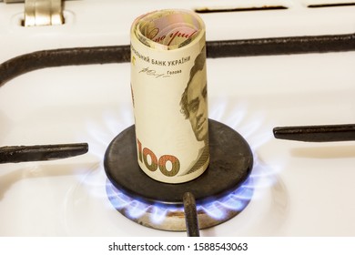 Stack Of One Hundred Hryvnia Notes On A Gas Stove In The Center Of Gas Comfort, Gas Burns.