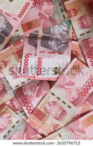 Stack of One Hundred Thousand Rupiah Banknotes in red or pink. Close-up shot of one hundred thousand rupiah banknotes. Indonesian Currency. Indonesian rupiah for background. 