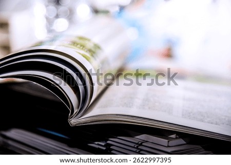 Stack of open books with light and bokeh