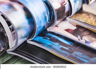 stack of open colorful magazines. information